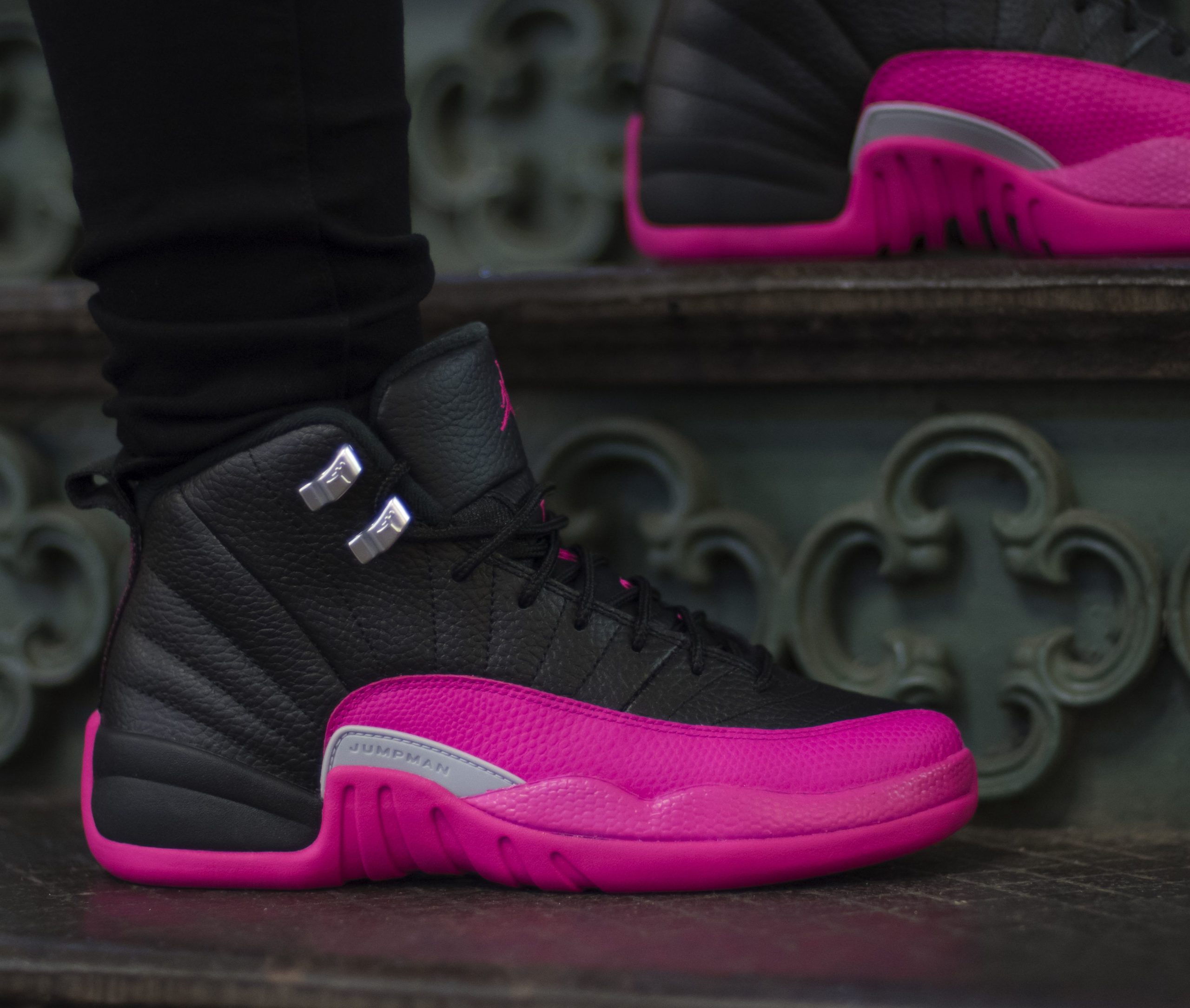 Pink and black store jordans 12